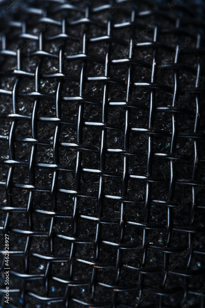 The metallic texture of the microphone grille is a full-screen close-up The metallic texture of the microphone grille is a full-screen close-up