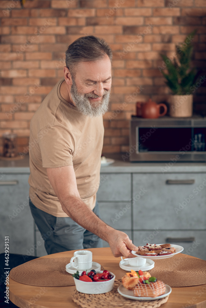 A man getting the breakfast ready and looking involved