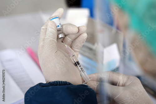 Doctor holding a syringe with liquid sinovac vaccines Concept fight against virus covid19