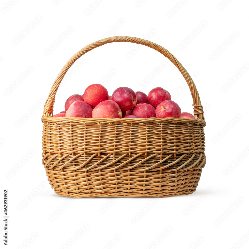 Isolated wicker basket with red ripe apples on white background Isolated wicker basket with red ripe apples on white background