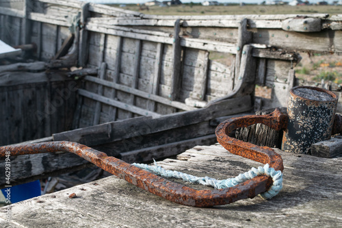 Close up rusted steering tiller on old wooden fishing boat at Dungeness, Kent, England photo