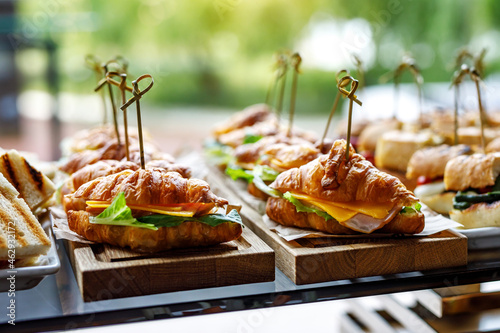 Obraz na plátne Stacks of croissant sandwich at event.