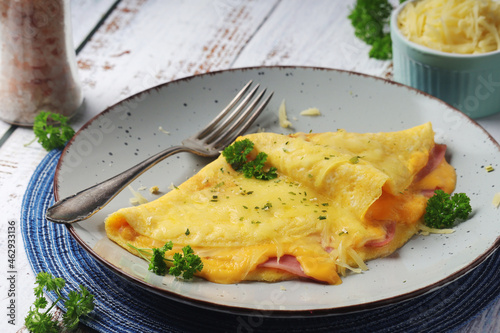 Omelette with ham and cheese on the plate	