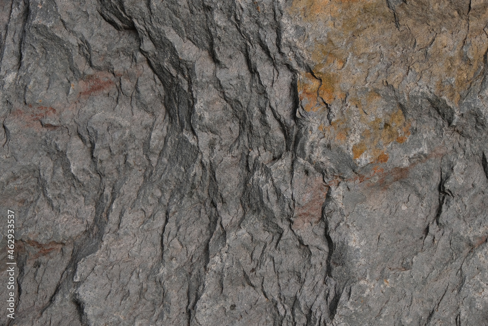 Gray stone with rusty spots background. Stone faults traces. Selective focus. Gray stone with rusty spots background. Stone faults traces. Selective focus.