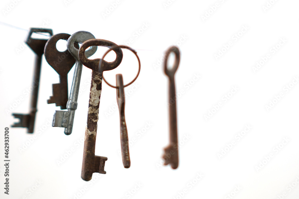 A different old retro keys from different locks hanging on string, selective focus A different old retro keys from different locks hanging on string, selective focus
