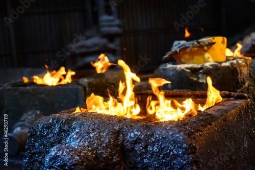 Steel molds for metal pouring. A fire burns at the top of the molds