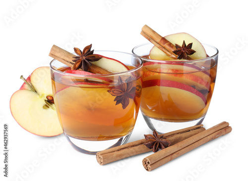 Hot mulled cider and ingredients on white background photo