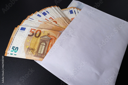 Lots of 50 euro banknotes in a white envelope. The concept of corruption. Cash savings. Softf ocus photo