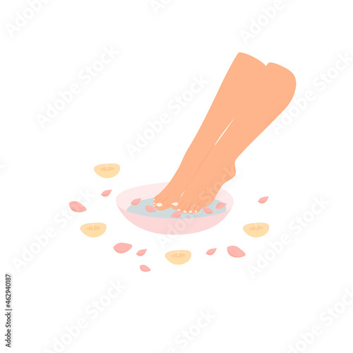 Female legs with a pedicure. Foot bath with candles and rose petals. Noe and toenail care. Beauty and spa treatments.