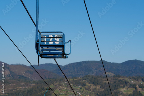 Old non-working chair lift in mountains photo