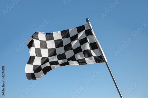 Checkered finish flag on light blue background