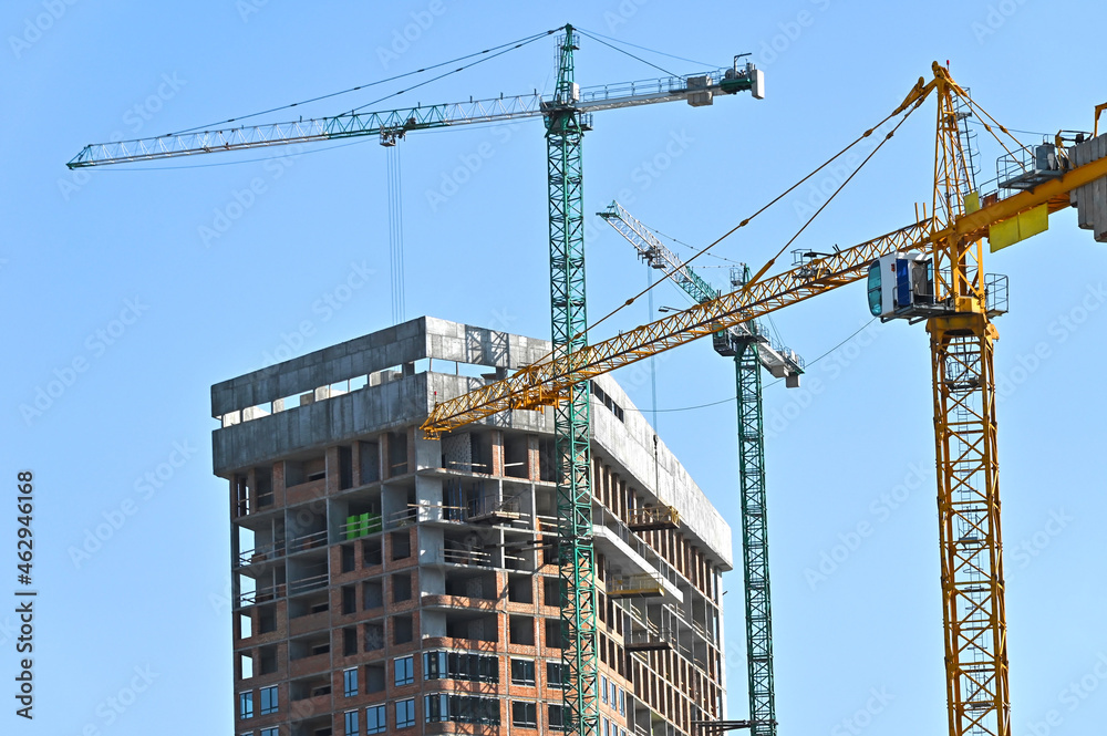 Crane and highrise construction site Crane and highrise construction site
