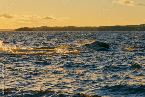 Ripples from the waves on the surface of the water on the lake at sunset.