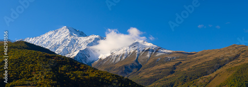 Mountain landscape with snow-capped peaks against the blue sky
