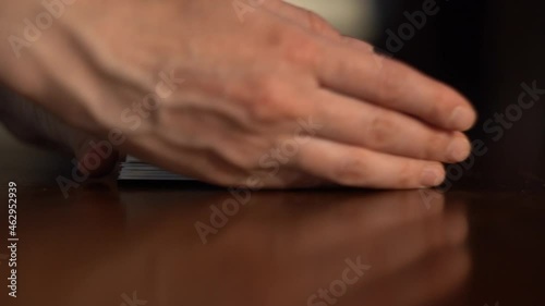 Female hands collect Tarot cards in a pile