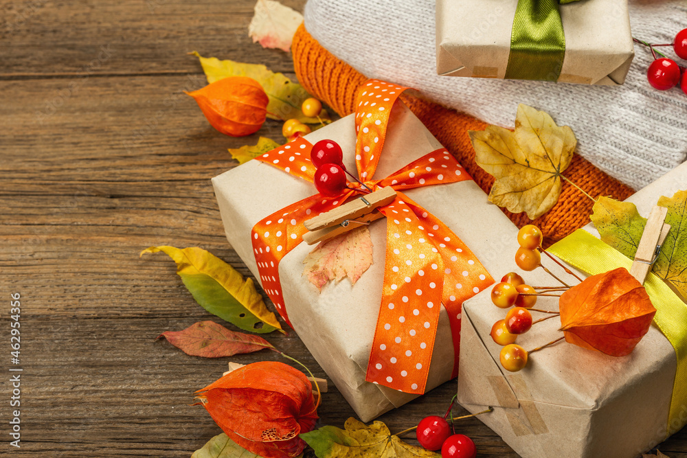 Zero waste gift concept with autumn design. Warm sweaters, fall leaves, thematic decor