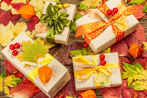 Zero waste gift concept with autumn design. Warm sweaters  fall leaves  thematic decor