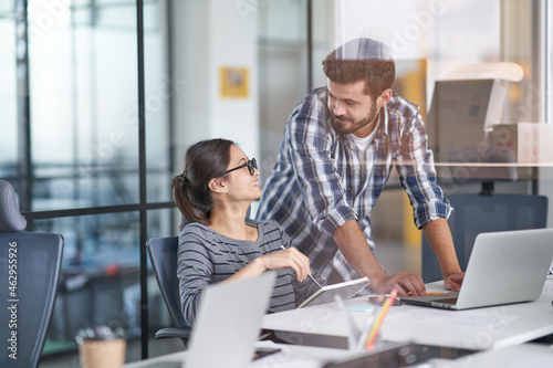 Worker speaking about new projects with director