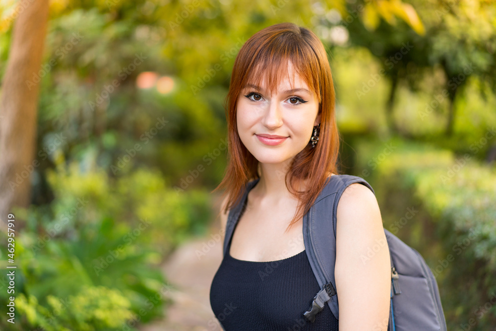 Young pretty redhead woman at outdoors . Portrait