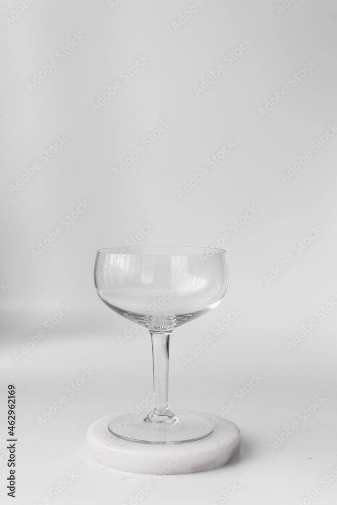 Empty coupe glass on marble coaster Empty coupe glass on marble coaster