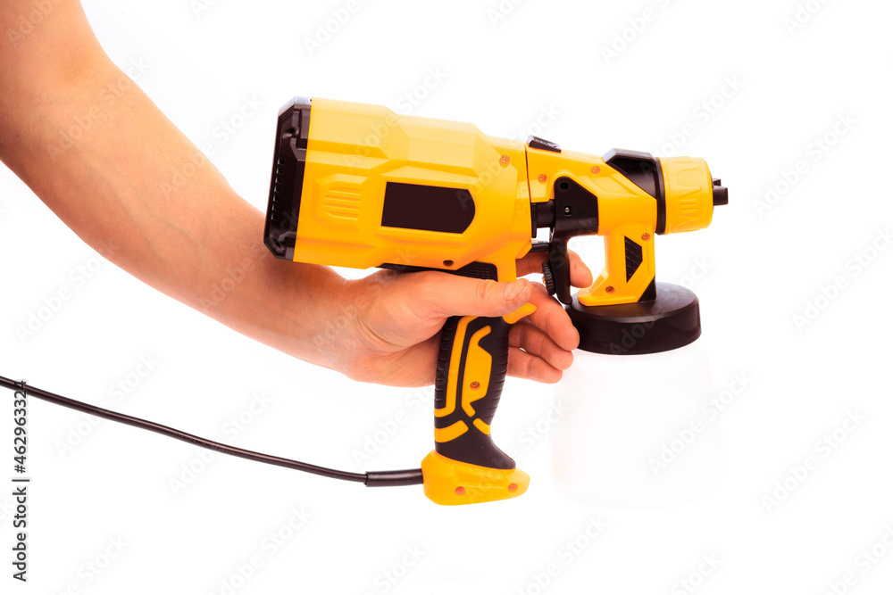 Fototapeta premium paint gun holding by mans hand isolated on white background - Image
