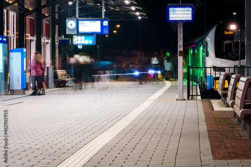 Train station with moving people getting on and off the train on arrival and departure platform © fotografiecor