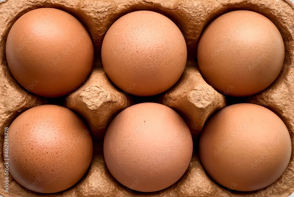 Half of dozen of brown organic free range eggs in recycling carton box. Selective focus. Close up. Half of dozen of brown organic free range eggs in recycling carton box. Selective focus. Close up.