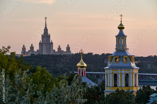 Russia. Moscow at sunset. The main building of Moscow State University, the Church of the Ascension and the Church of St. John the Theologian in the Andreevsky Monastery