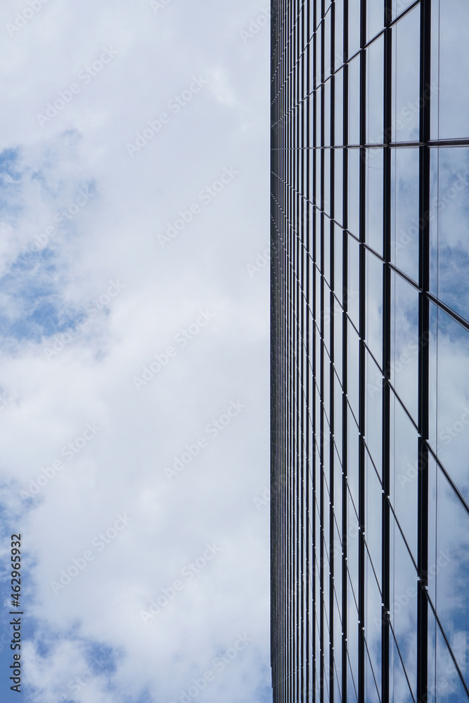 The skyscraper with the clouds reflected in the windows