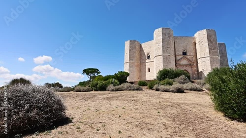 Andria, Puglia, Italy. August 2021. POV footage walking around Castel del Monte. On a magnificent summer day with clear skies, the fort dominates the scene.