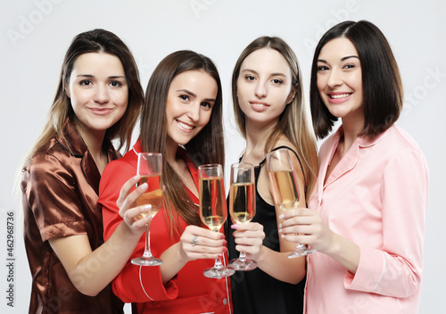 beautiful girls dressed in pajamas drink champagne and have fun