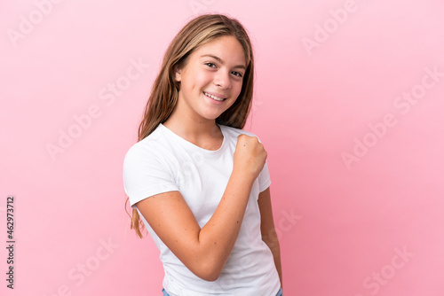 Little caucasian girl isolated on pink background celebrating a victory
