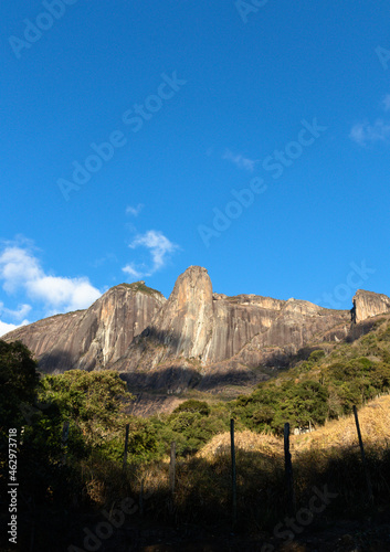 Panorama of the stone wall of the Torres de Bonsucesso mountain range, composed of three tall towers, located in the Três Picos State Park (PETP), Teresopolis, Rio de Janeiro, Brazil photo