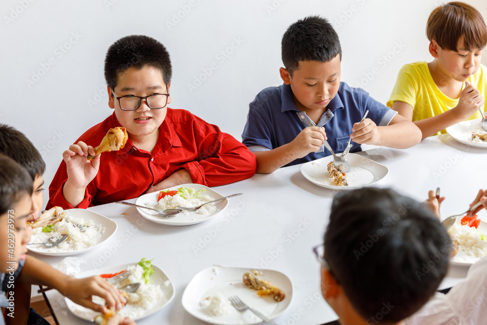 Group Of Children Eating Lunch In School