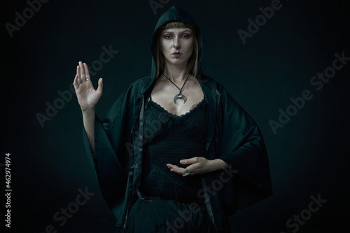 Tablou pe pânză Young pagan witch, a moon priestess, performing a ritual, halloween and feminini