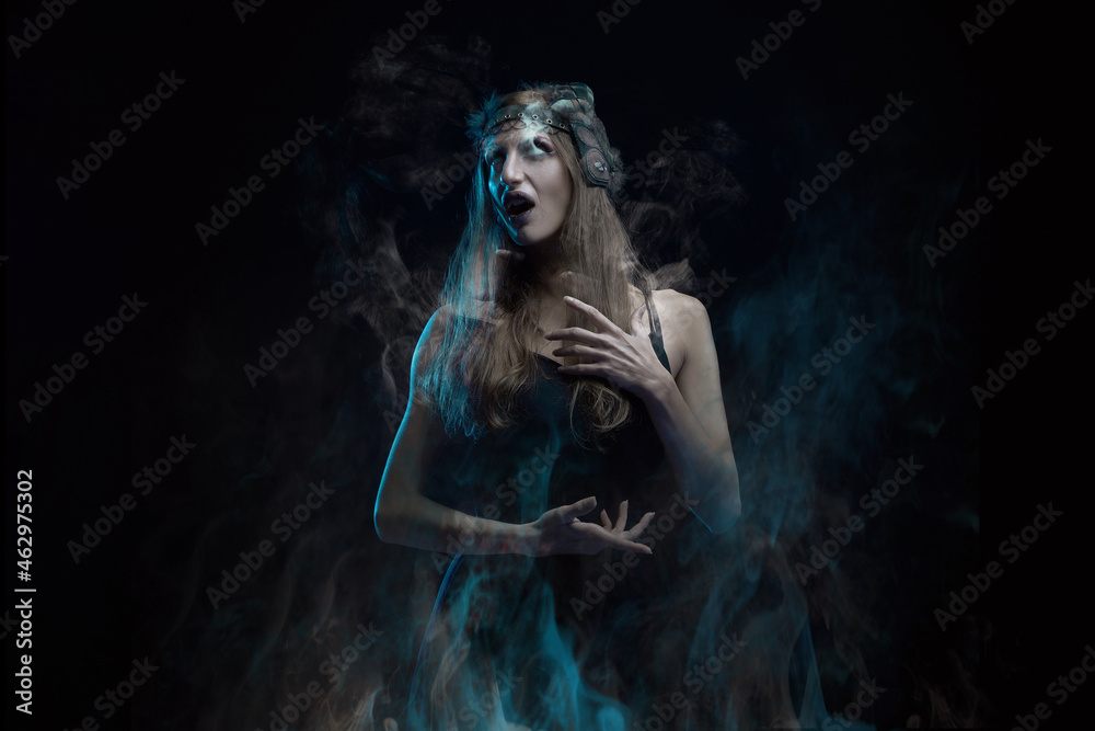 Burning vampire or witch woman, screaming in agony, drowning in flames, dark halloween concept