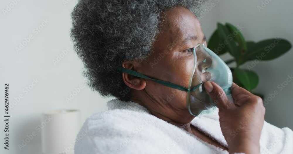 African american senior woman breathing using an oxygen mask at home