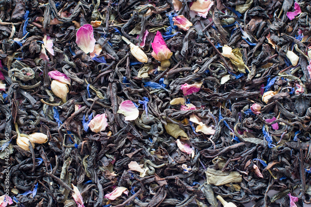 Mix tea with dried fruits and dried flowers. Tea background. Black tea with pink and blue petals. Health. Mix tea with dried fruits and dried flowers. Tea background. Black tea with pink and blue petals. Health.
