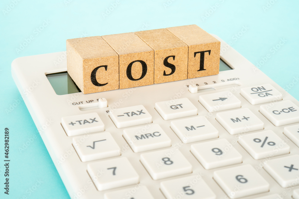 Concept of cost calculation (calculator and the word “COST”) - obrazy, fototapety, plakaty 