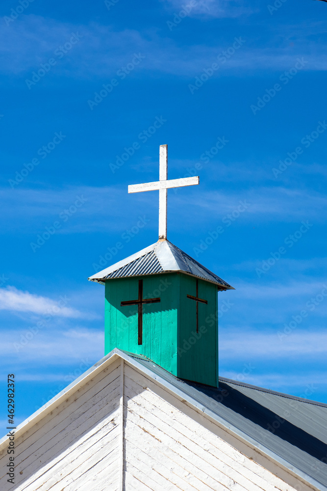 Green steeple with white cross on the steeple of an old church in New Mexico’s Manzano Mountains Green steeple with white cross on the steeple of an old church in New Mexico’s Manzano Mountains