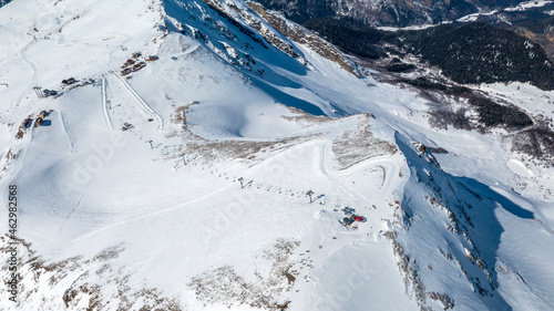 Caucasus Mountains, Panoramic view of the ski slope with the mountains Belalakaya, Sofrudzhu and Sulakhat on the horizon in winter day. Dombai ski resort, Western Caucasus, Karachai-Cherkess, Russia. photo