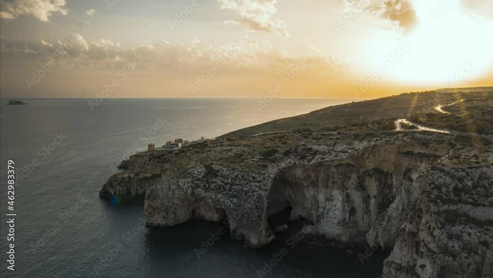 Golden hues during sunset over ocean from Blue Grotto, Malta, time-lapse