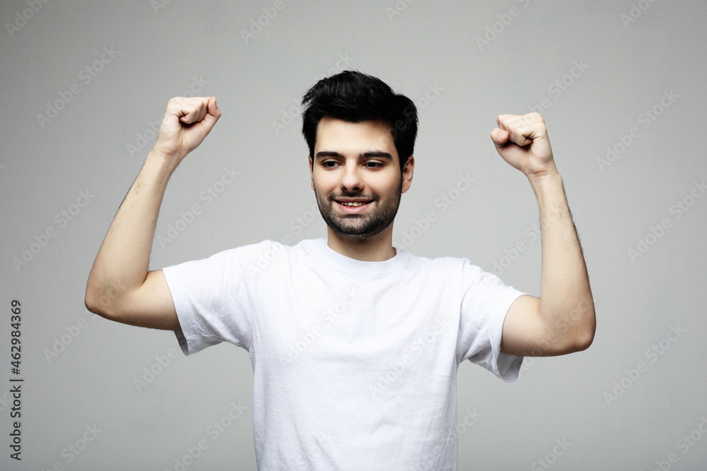Fototapeta premium young man celebrating victory over white background