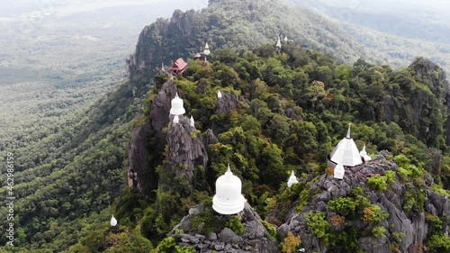 Backwards Flying Revealing Aerial Drone Shot Looking Over Wat Chaloem Phra Kiat Phrachomklao Rachanusorn, Temple of the Floating Pagodas, Lampang, Northern Thailand.