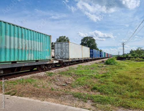 The train is carrying containers. diesel engine train of Thailand