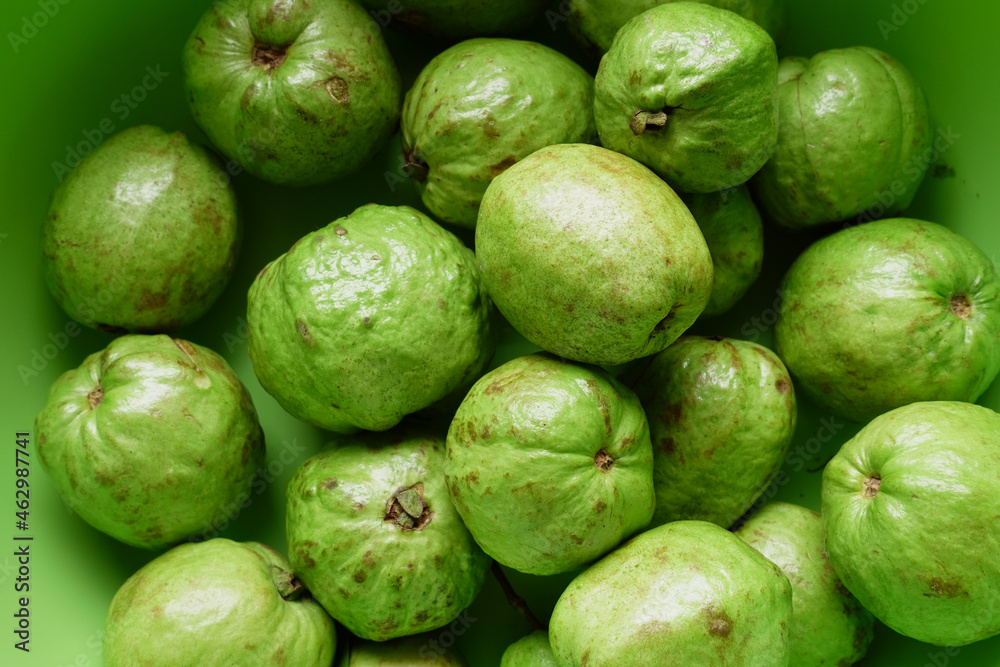  many guava in a bowl on table top view 