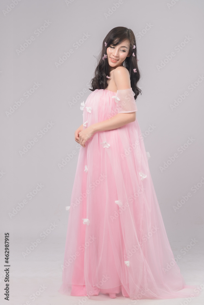 Portrait of beautiful asian woman bride in pink dress. Thai model posing in studio just married wedding concept. Portrait of beautiful asian woman bride in pink dress. Thai model posing in studio just married wedding concept.