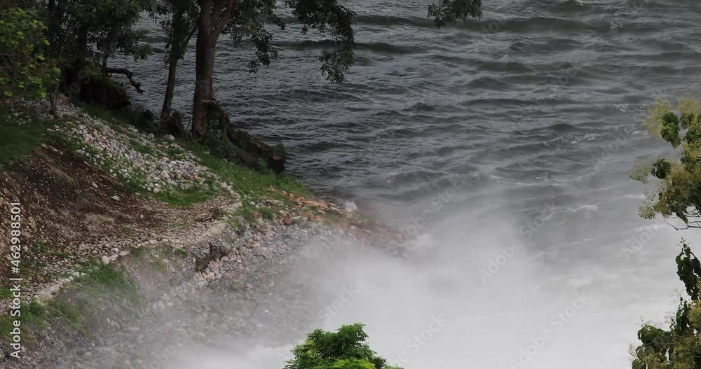 Water Raging from a Dam at Kaeng Krachan Reservoir in Thailand with thick Mist Rising Upward. Water Raging from a Dam at Kaeng Krachan Reservoir in Thailand with thick Mist Rising Upward.