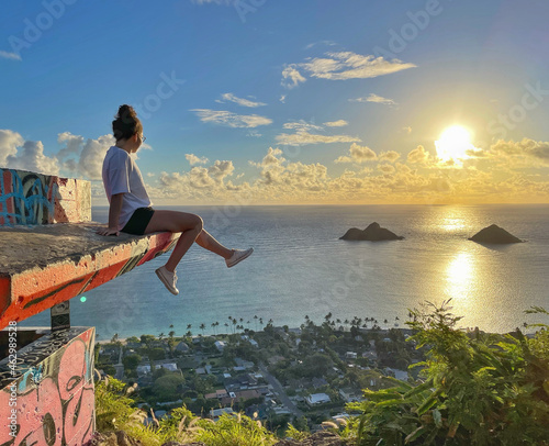 Person on the beach at sunrise in Hawaii. Views from Lanikai Pillbox hike.