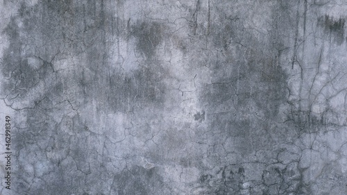 The old cement wall was weathered, the surface was scratched, the surface was scratched and damaged. For a mysterious retro-conservative background.